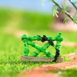 Miniature green resin bamboo fence for DIY micro landscape and moss terrarium decoration.