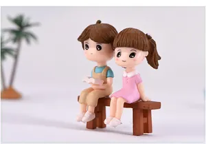 Miniature resin couple figurines reading on a bench for succulent micro-landscape decor