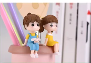 Close-up view of cute resin boy and girl couple figurines for DIY miniature landscape