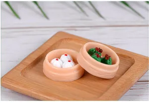 Detailed macro view of miniature resin steamed buns and dumplings in tiny steamers