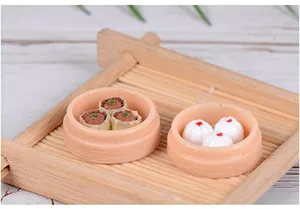 Close-up macro of miniature resin steamed buns and shumai figurines for dollhouse