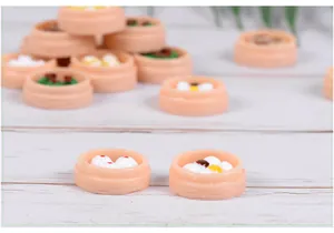Macro detail of miniature resin dim sum models featuring dumplings in bamboo steamers