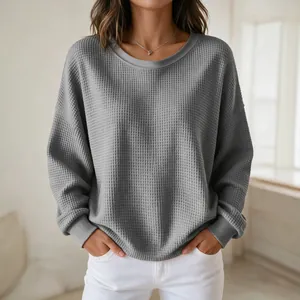 Close-up detail of grey waffle knit texture on this women's round neck sweatshirt