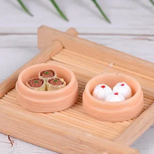 Miniature resin food ornaments featuring xiaolongbao and shaomai in steamers for micro decor