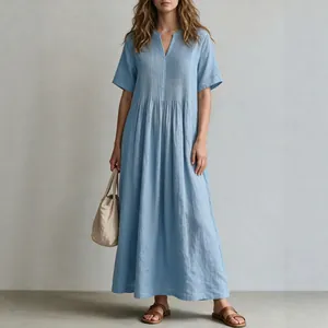 Full-length view of a light blue pleated cotton linen maxi dress with V-neckline.