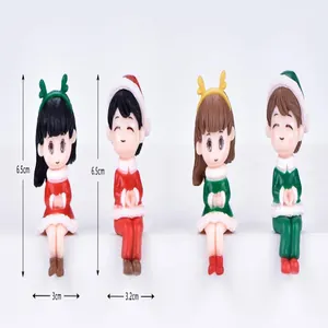 Detail view of Christmas couple figurines showing height 6.5cm and widths 3cm-3.2cm.