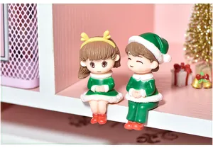 Macro view of cute Christmas couple figurines for micro landscape and desktop decor