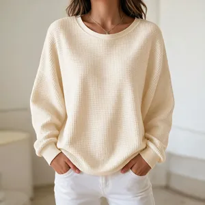 Macro view showing the soft waffle knit texture of this women's cream sweatshirt
