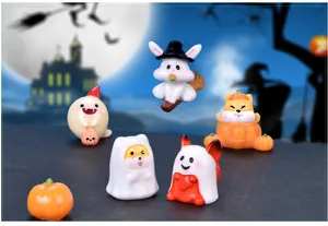 Detailed view of cute Halloween resin figurines featuring ghost dog and pumpkin rabbit