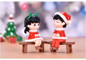 Detailed view of Christmas sitting couple figurines for festive micro-landscape decor