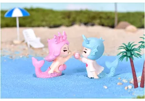Detailed view of cute mermaid couple figurines in a beach theme miniature micro-landscape