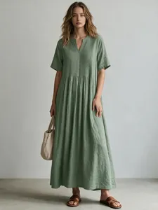 Detailed view of sage green cotton linen maxi dress with pleated V-neck design