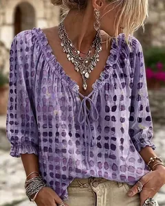 Blusa de verano bohemia morada con lunares, mangas con volantes y cuello en V con cordón.