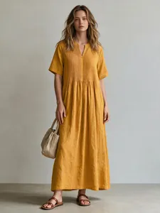 Full-length studio shot of a yellow V-neck pleated cotton linen casual long dress for women