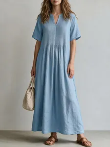 Detailed view of a light blue pleated cotton linen maxi dress with a V-neck design