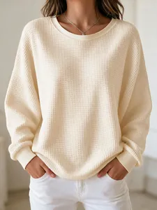 Close-up of cream waffle knit long sleeve sweatshirt with round neck and drop shoulder