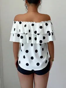 Detail of women's off-the-shoulder polka dot blouse featuring ruffled layers and back view.