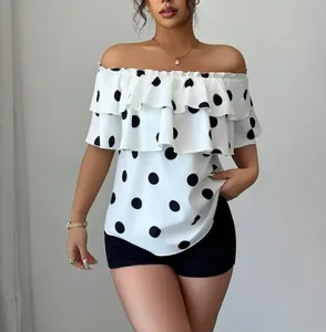 Macro view of white off-the-shoulder polka dot blouse featuring elegant layered ruffles