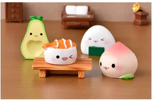 Close-up of kawaii resin food miniatures including avocado and sushi in a dollhouse setting.
