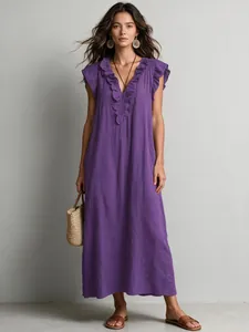 Detail of purple bohemian maxi dress featuring ruffled v-neck and flutter sleeves