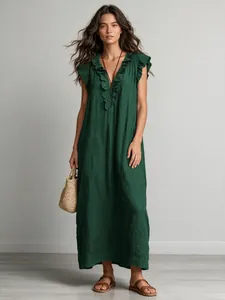Close-up of a bohemian dark green maxi dress with ruffled flutter sleeves and neckline.