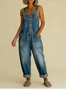 Close-up of retro distressed denim overalls with adjustable straps and pockets