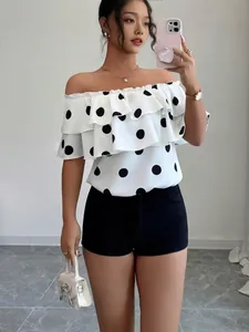 Chic off-the-shoulder polka dot blouse for women in a stylish summer vacation outfit