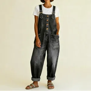Vintage distressed loose women's denim overalls with adjustable straps on neutral background