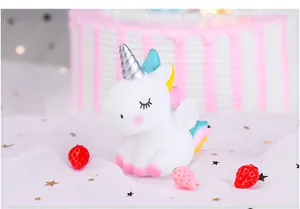 Detailed macro shot of a cute white vinyl unicorn figurine for cake and birthday decoration