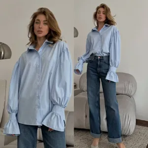 Elegant light blue oversized women's button-down shirt featuring stylish lantern sleeves