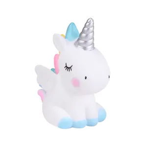 Cute white unicorn cake topper vinyl ornament with silver horn and blue wings detail