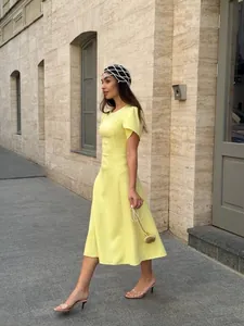 Elegant solid yellow slim waist midi dress for women featuring a minimalist summer design