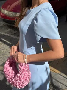Side view of a light blue summer dress with elegant petal-style sleeves