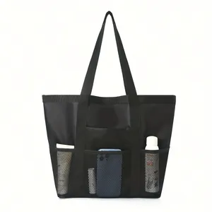 Front view of black mesh beach bag featuring multiple storage pockets for items