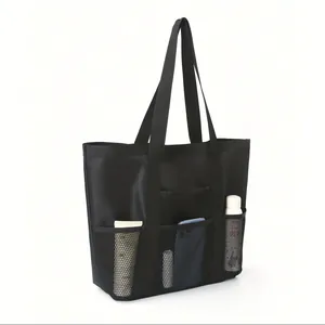 Detail of black foldable mesh beach bag with side pockets for shower and gym use