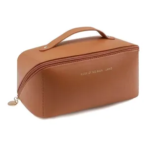 Large capacity tan portable travel cosmetic bag with a sturdy handle and zipper