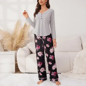Cozy two-piece women's pajama set featuring grey long-sleeve Henley top and floral pants