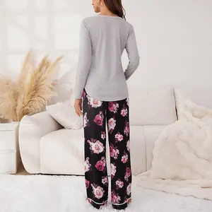 Cozy women's two-piece floral pajama set with grey long-sleeve top and rose print pants