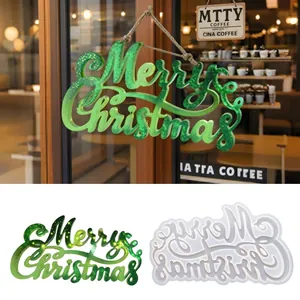 Green glittery resin 'Merry Christmas' sign decoration hanging on a cafe glass door