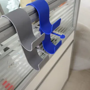 Detail view of durable plastic swimming pool pipe holders in gray and blue colors.