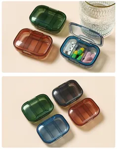 Portable multi-compartment pill box cases in various transparent colors with pills