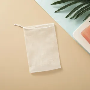Dettaglio della rete schiumogena bianca a maglia fine con coulisse per sapone fatto a mano