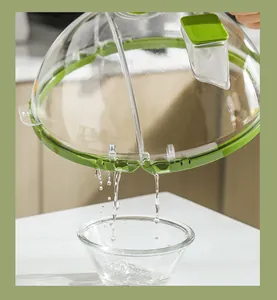 Macro view of transparent microwave splatter cover draining water into a glass bowl