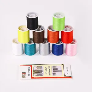 Detailed view of colorful sewing thread spools and a pack of gold-eye needles set.