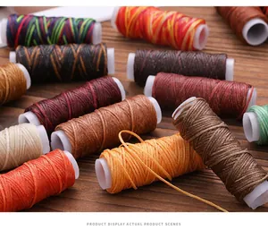 Detailed macro view of multi-color 150D flat waxed thread spools for leather DIY sewing.