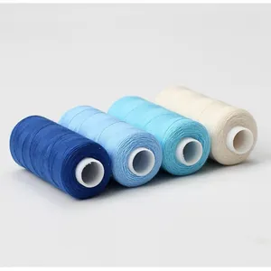 Set of 402 sewing thread spools in shades of blue and cream on a plain white background