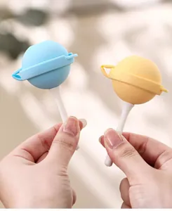 Close-up of blue and yellow planet-shaped silicone lollipop ice pop molds for kids.