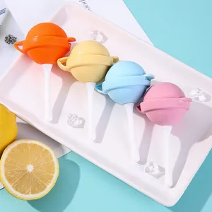 Mini silicone lollipop ice pop molds in four bright colors displayed on a white tray