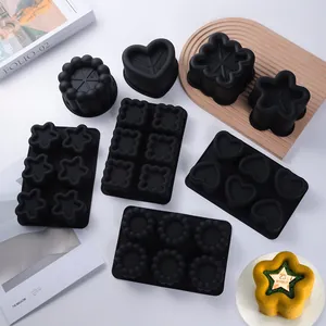Black silicone mousse cake molds in various shapes including heart and star.