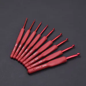Detailed macro view of red TPR soft handle crochet hooks with various size engravings